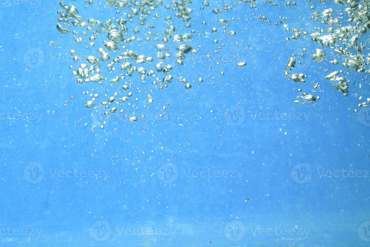fresh water with underwater bubbles texture on a blue background close-up abstract liquid bubbles aqua design wallpaper photo
