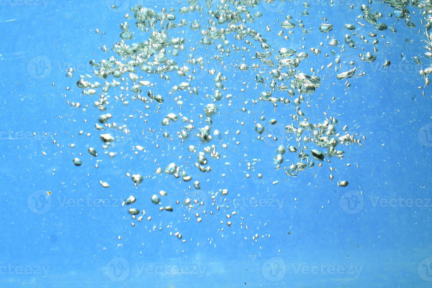 fresh water with underwater bubbles texture on a blue background close-up abstract liquid bubbles aqua design wallpaper photo