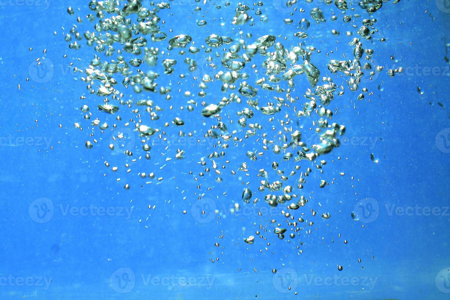 fresh water with underwater bubbles texture on a blue background close-up abstract liquid bubbles aqua design wallpaper photo