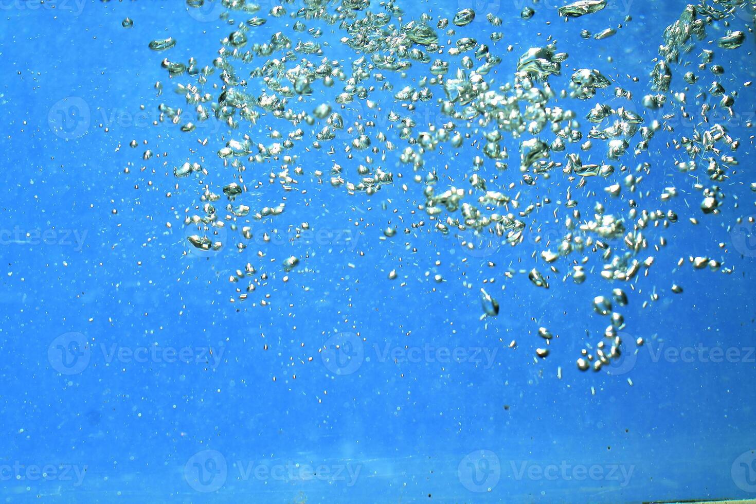fresh water with underwater bubbles texture on a blue background close-up abstract liquid bubbles aqua design wallpaper photo