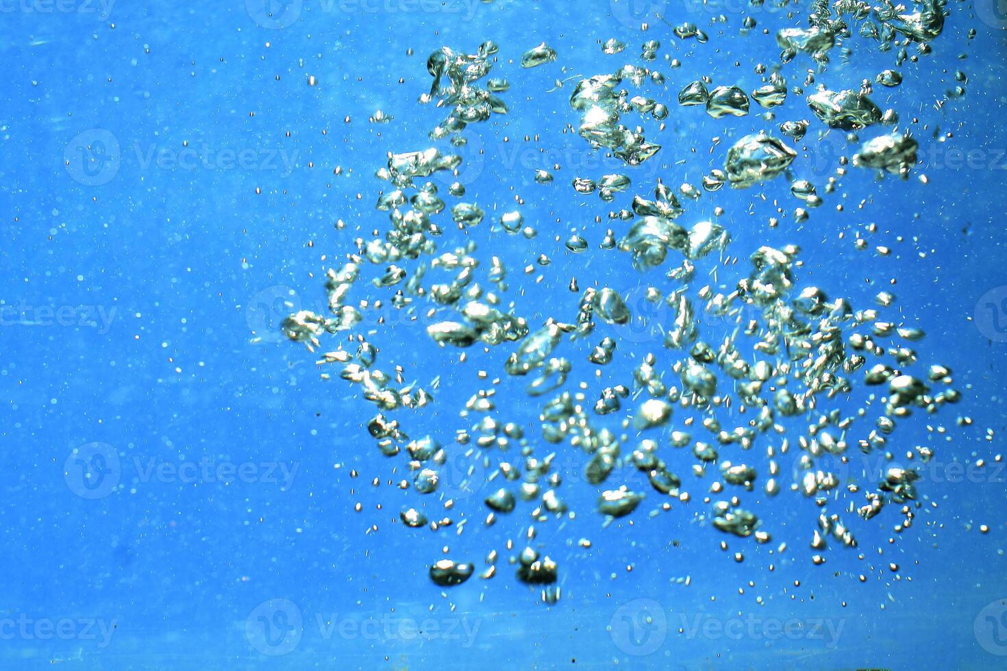 fresh water with underwater bubbles texture on a blue background close-up abstract liquid bubbles aqua design wallpaper photo
