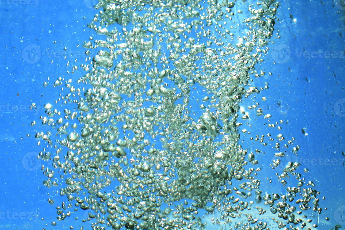 fresh water with underwater bubbles texture on a blue background close-up abstract liquid bubbles aqua design wallpaper photo