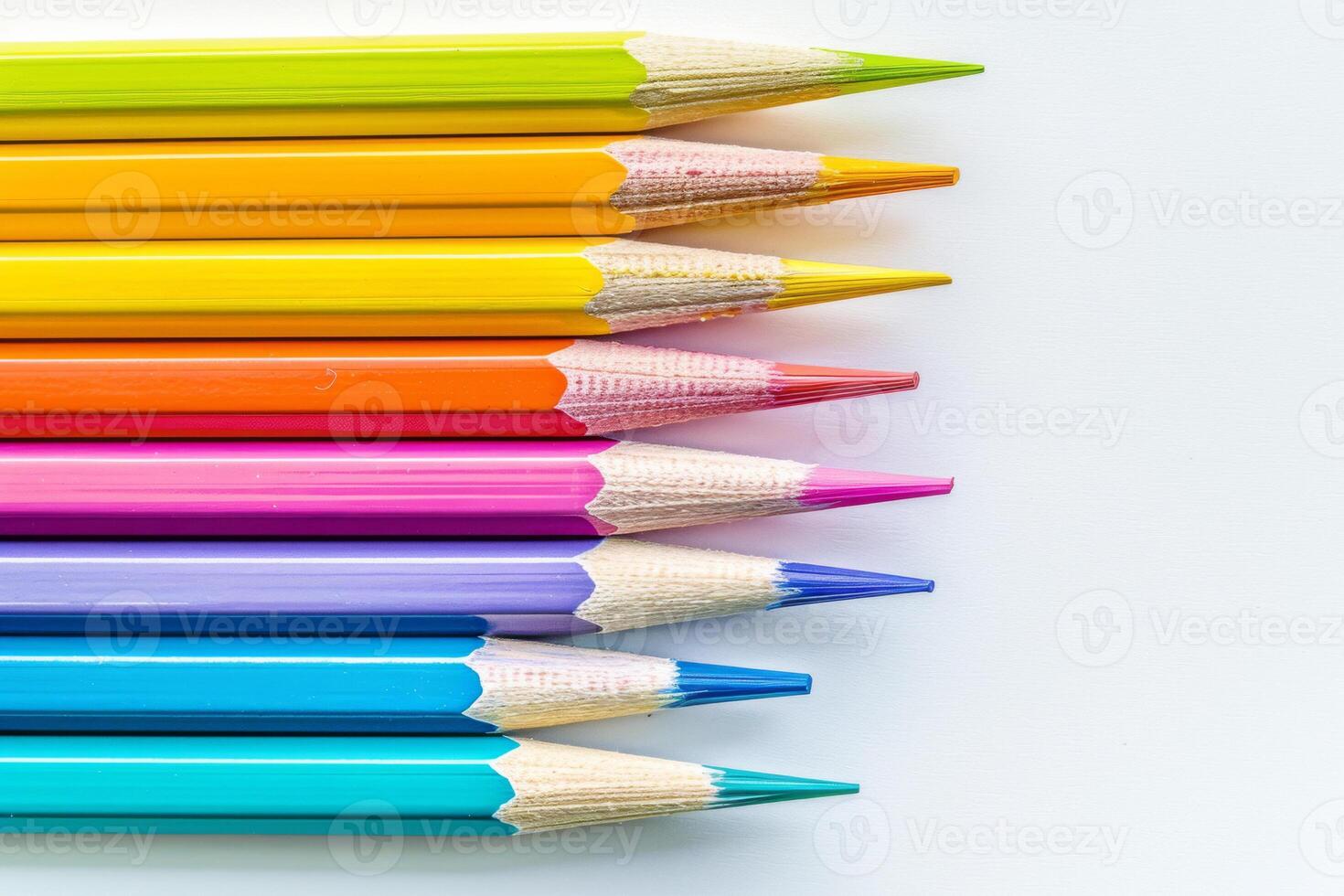 Office for school classes or art classes. Colored pencils arranged in a row on a white background in close-up. photo