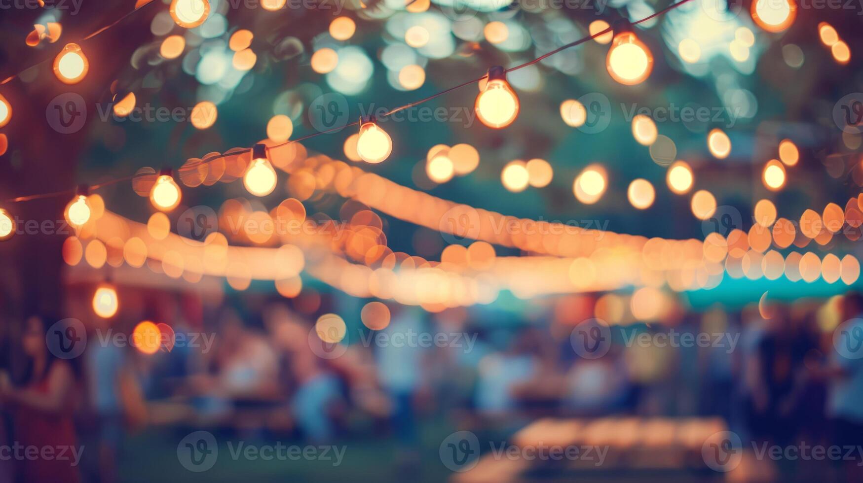 A blurred background with garlands and trees. An outdoor music festival. People are enjoying live music. The concept of a summer party. photo