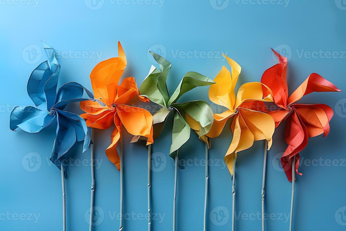 Colorful Paper Pinwheels on Blue Background - Festive Decoration for Parties and Events photo