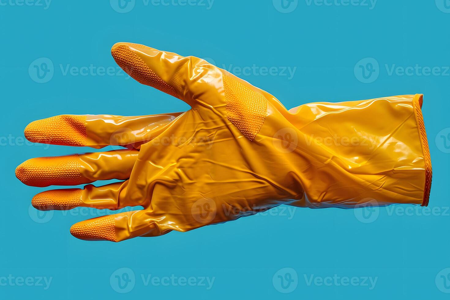 Yellow Rubber Cleaning Glove on Blue Background for Cleaning and Hygiene Concepts photo
