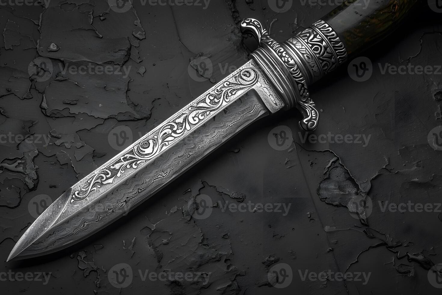 Intricately Designed Ornate Silver Knife on Textured Black Surface - Perfect for Historical and Artistic Displays photo