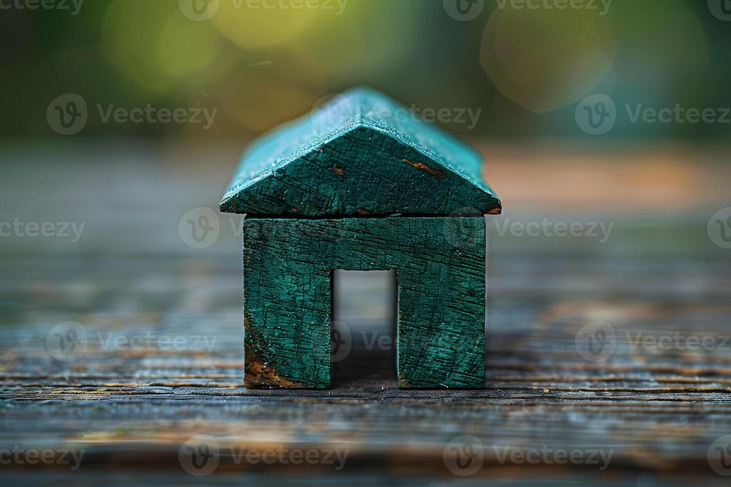 Rustic Wooden House Figurine on Weathered Wood Surface, Green Toned Decorative Accent for Home Decor and Art Projects photo