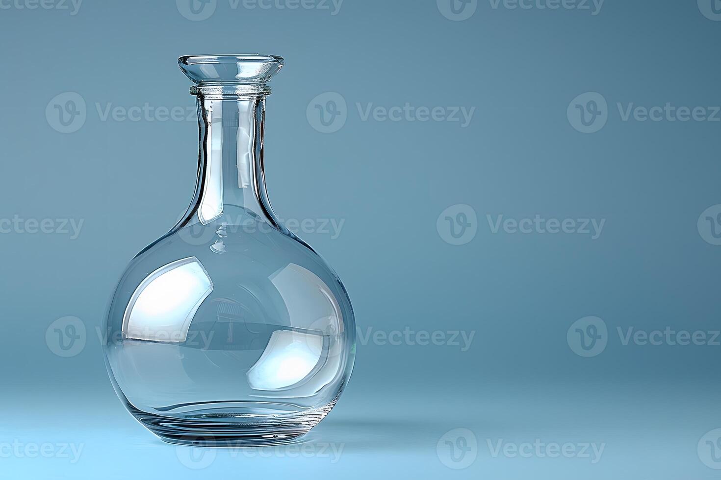 Clear Glass Decanter on Light Blue Background for Elegant Glassware Design photo