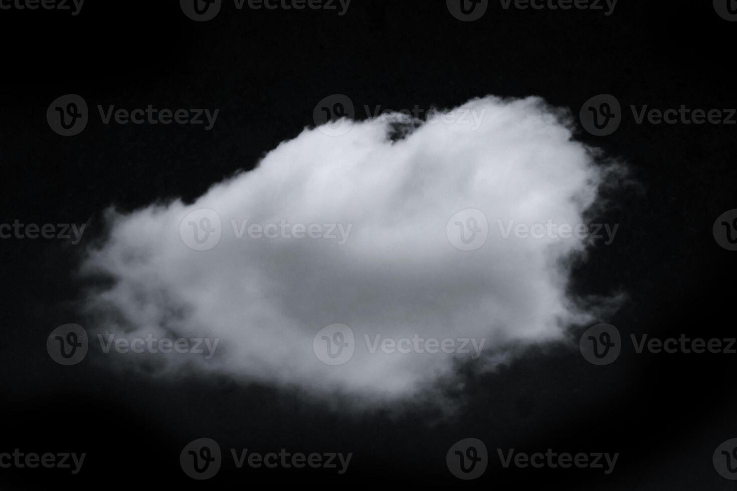 Single White Cloud Floating Against Dark Sky Background in Black and White Photography photo