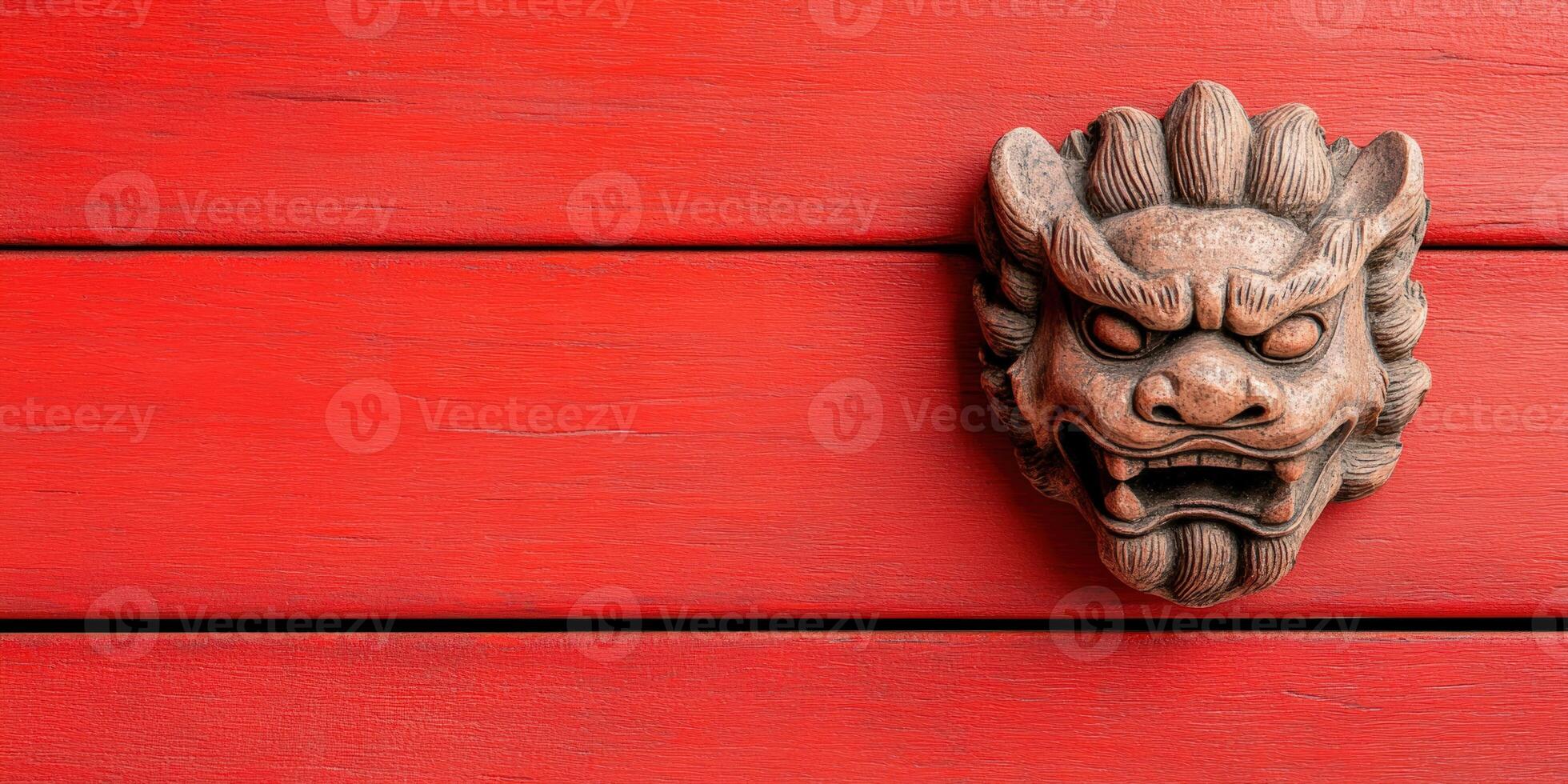 Ancient wooden lion head sculpture mounted on vibrant red wooden background showcasing traditional art. photo