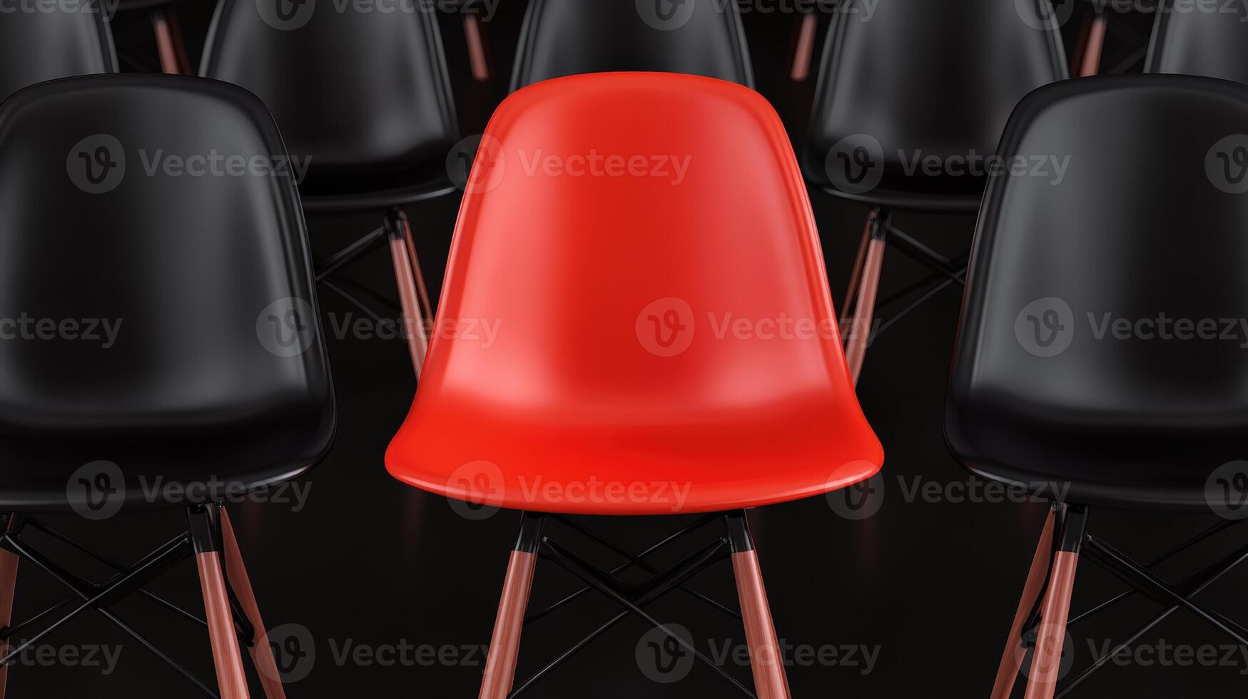 Red chair stands out among rows of black chairs, emphasizing individuality and unique design in a modern seating arrangement. photo