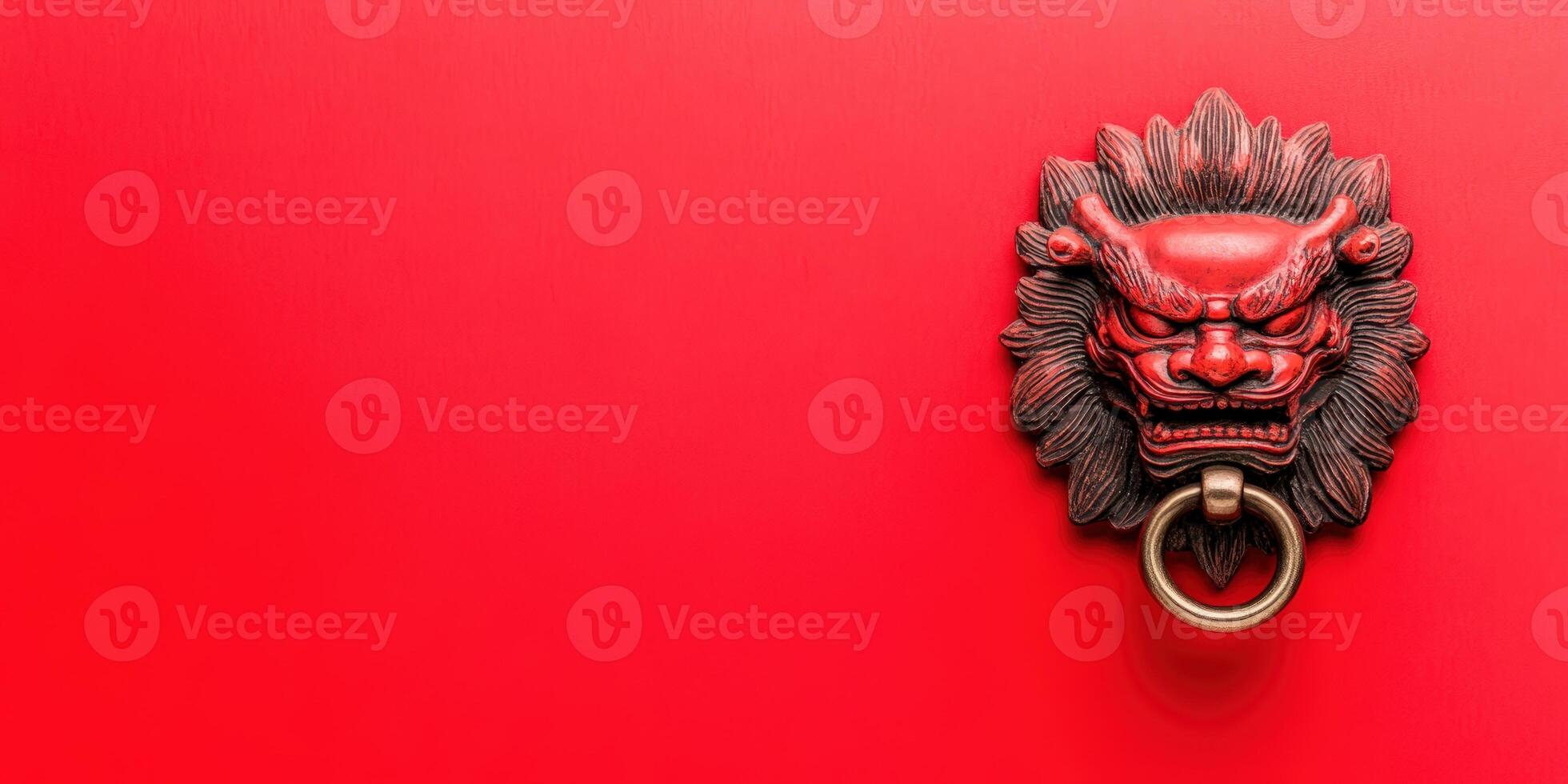 Vintage decorative lion head door knocker on a vibrant red wall, symbolizing strength and protection in traditional Asian art and architecture. photo
