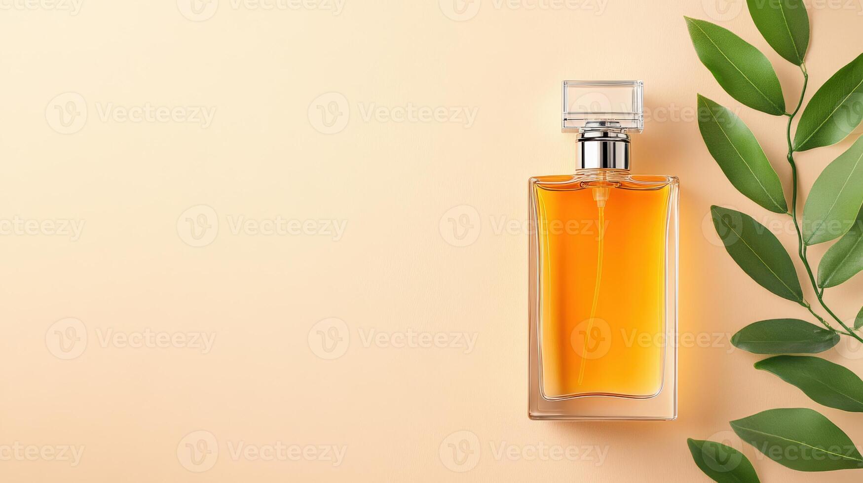 Elegant perfume bottle with orange liquid beside green leaves on a soft beige background, perfect for beauty and fragrance themes. photo