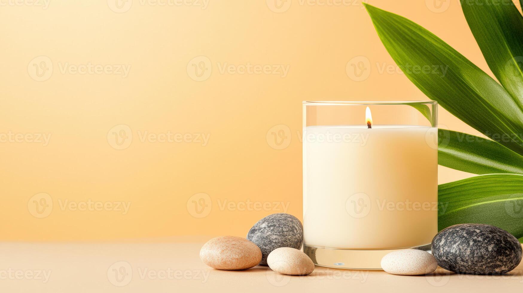 A serene setting featuring a lit candle, smooth stones, and lush leaves, creating a peaceful and relaxing atmosphere. photo