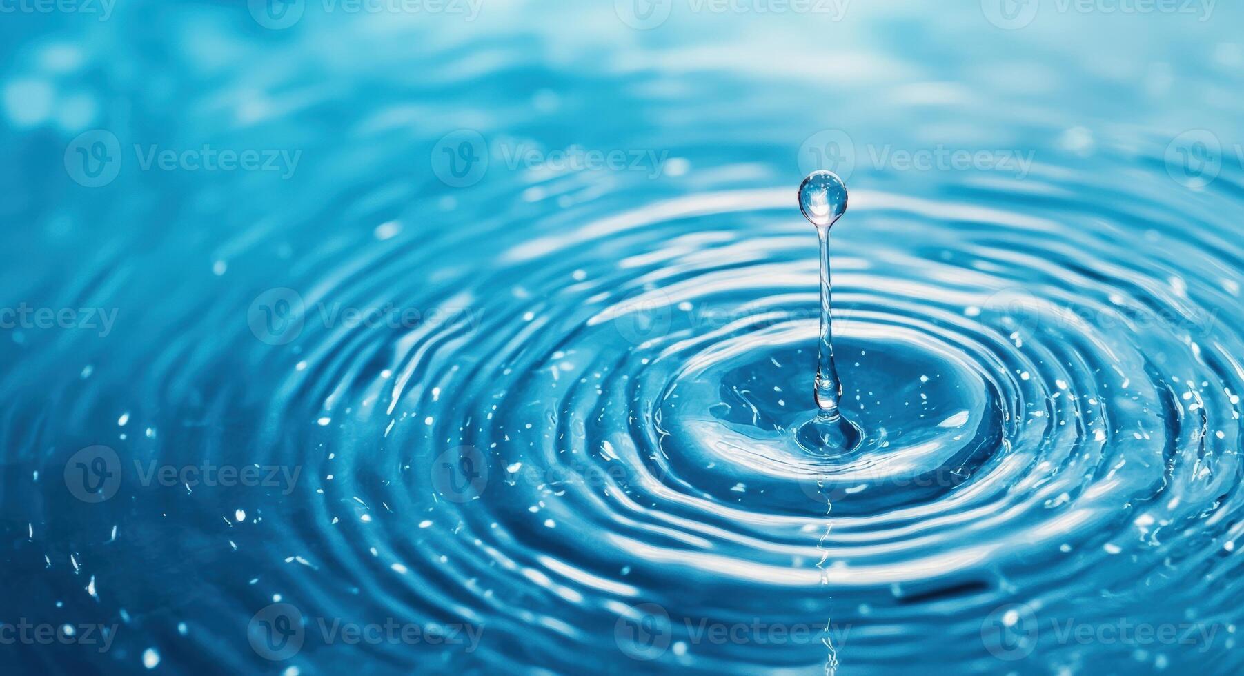 A close-up of a water droplet creating ripples in a serene blue background, capturing the essence of tranquility and freshness. photo