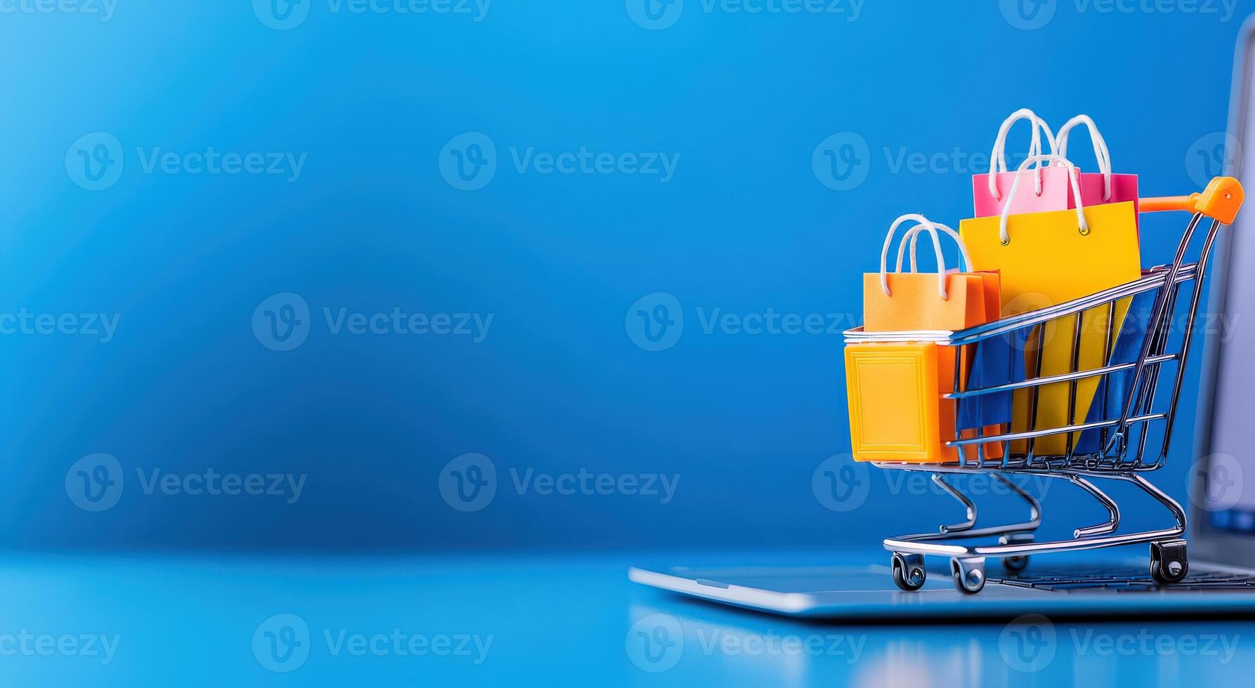 A colorful shopping cart with bags on a laptop, representing online shopping and e-commerce trends in a vibrant setting. photo