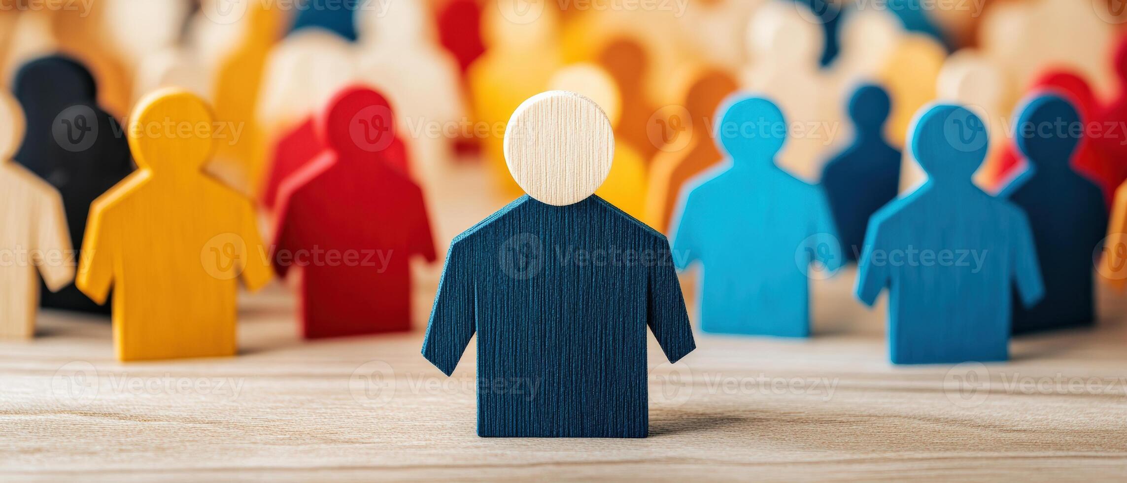 Colorful wooden figures standing together, symbolizing diversity, teamwork, and community engagement in a creative setting. photo