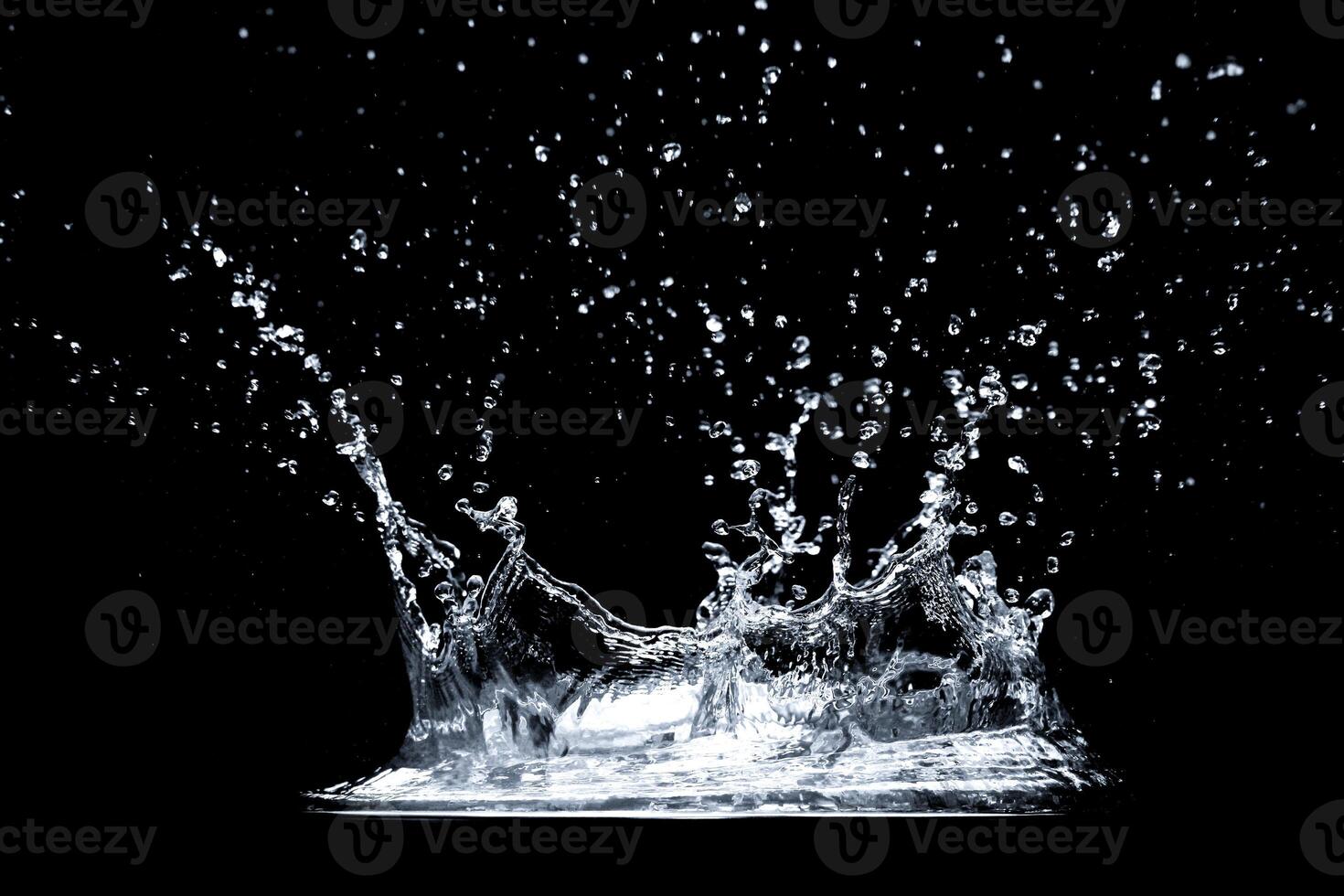 High-Speed Capture of Water Splash Against Black Background in Studio Lighting photo