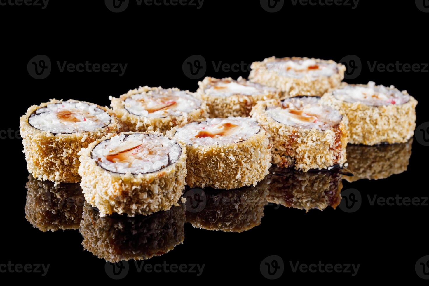 hot sushi roll tempura with eel shrimp crab salmon cream cheese cucumber avocado unagi on a black mirror background photo