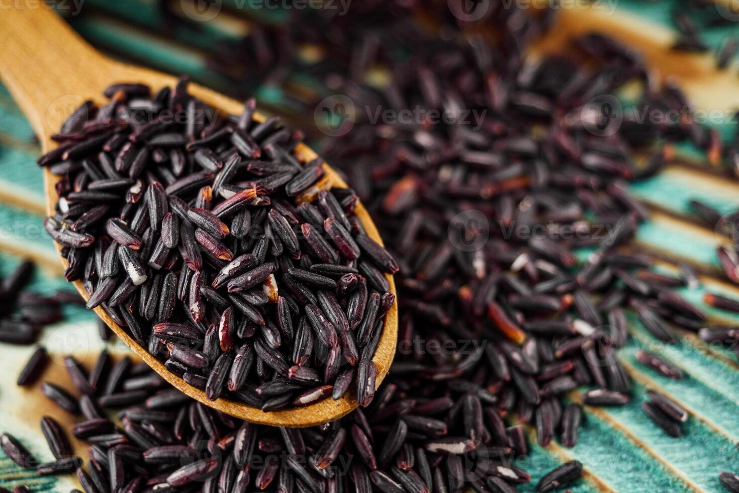 raw fresh black rice on wooden rustic background photo