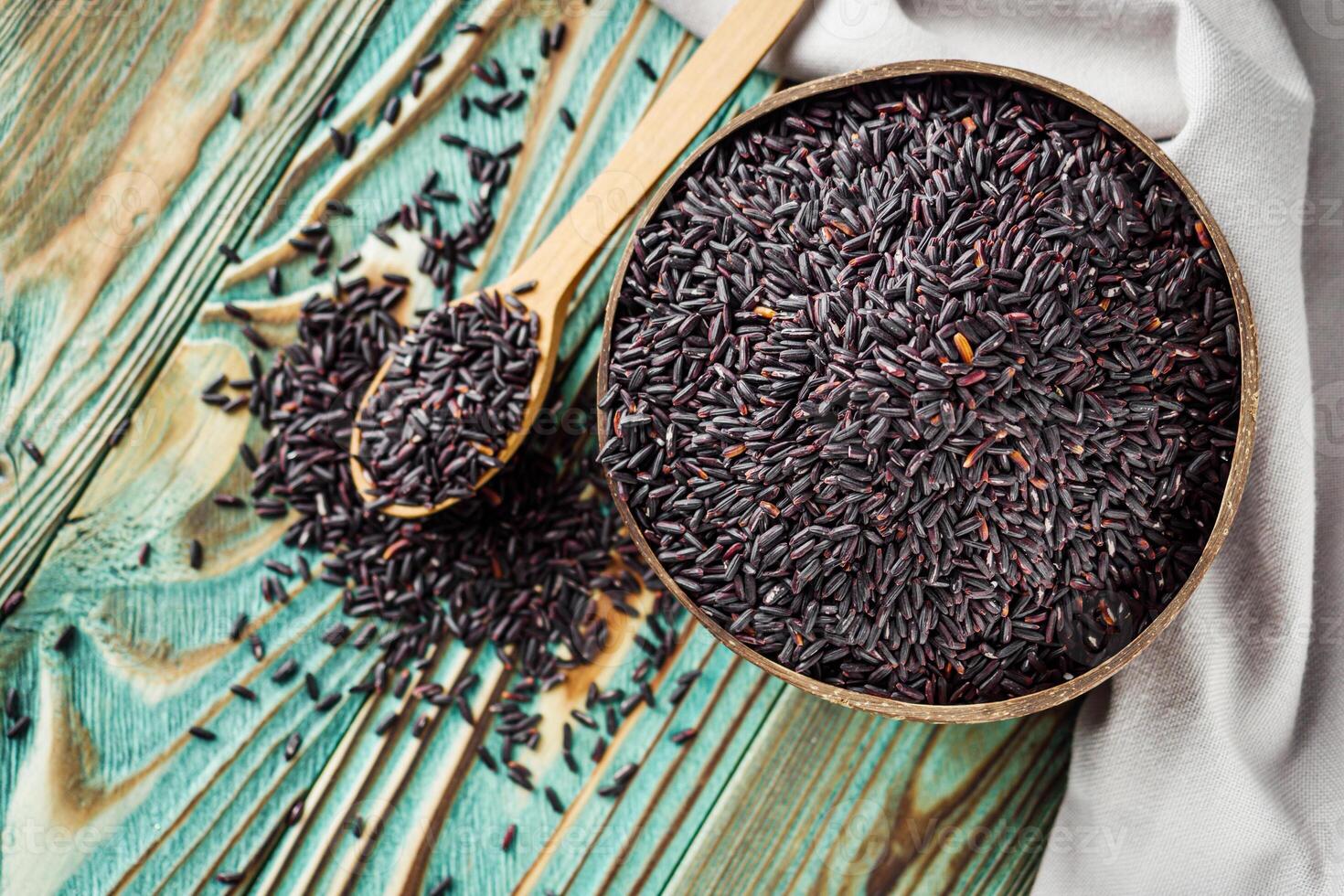 raw fresh black rice on wooden rustic background photo
