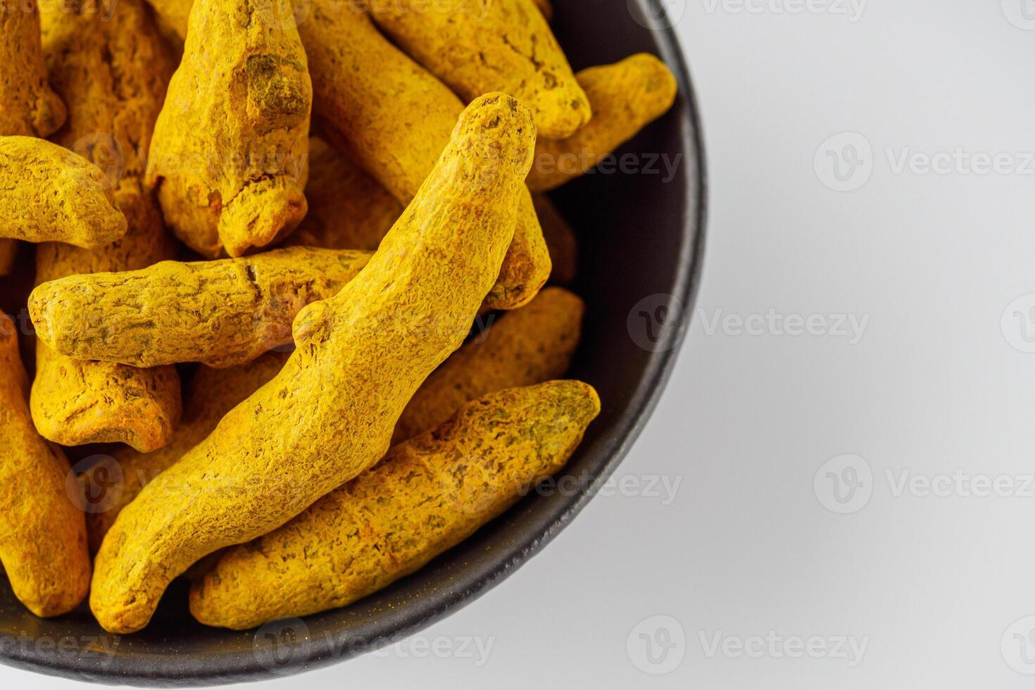 aromatic turmeric root on a white acrylic background photo