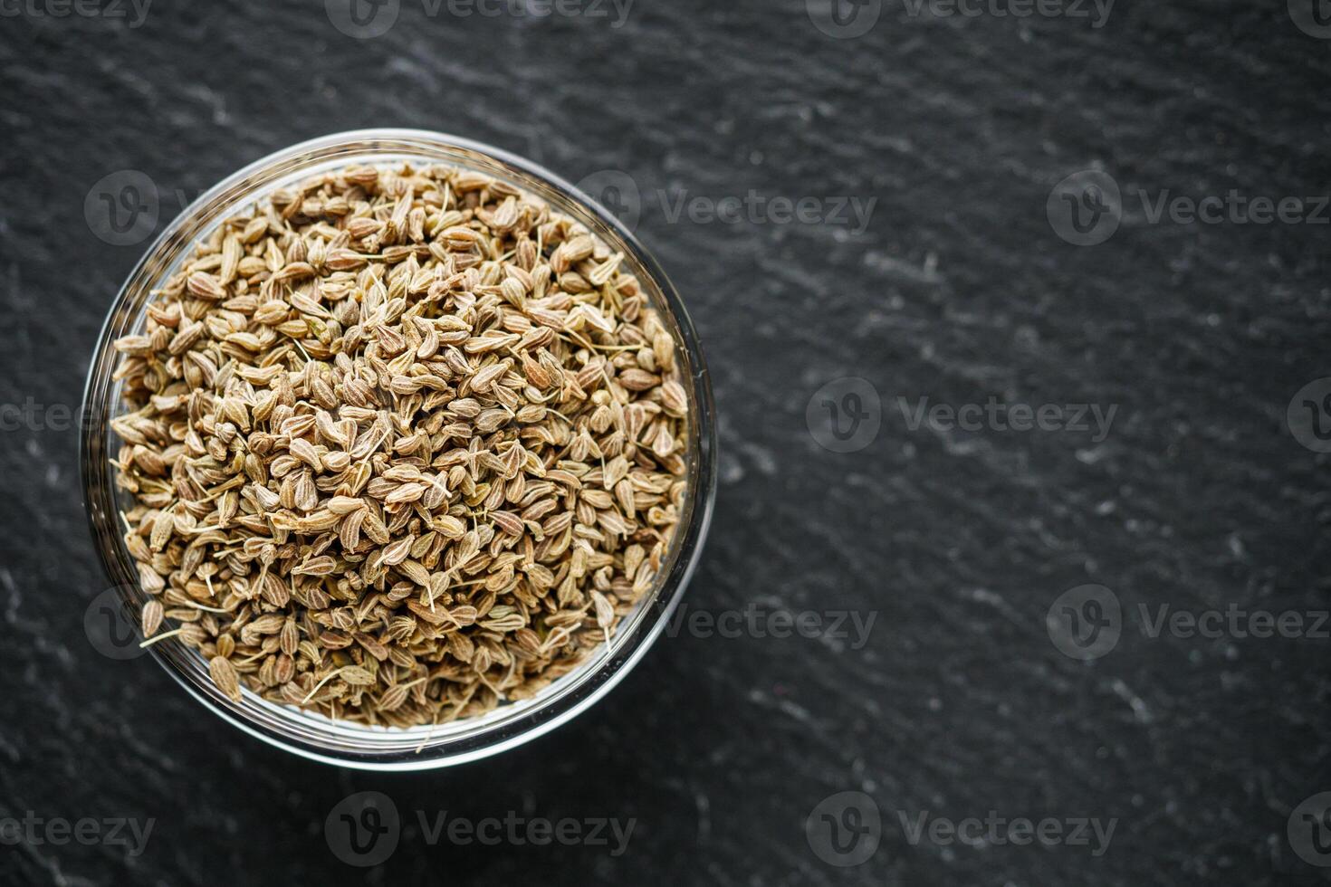 aromatic dry anise seeds on a dark black stone background photo