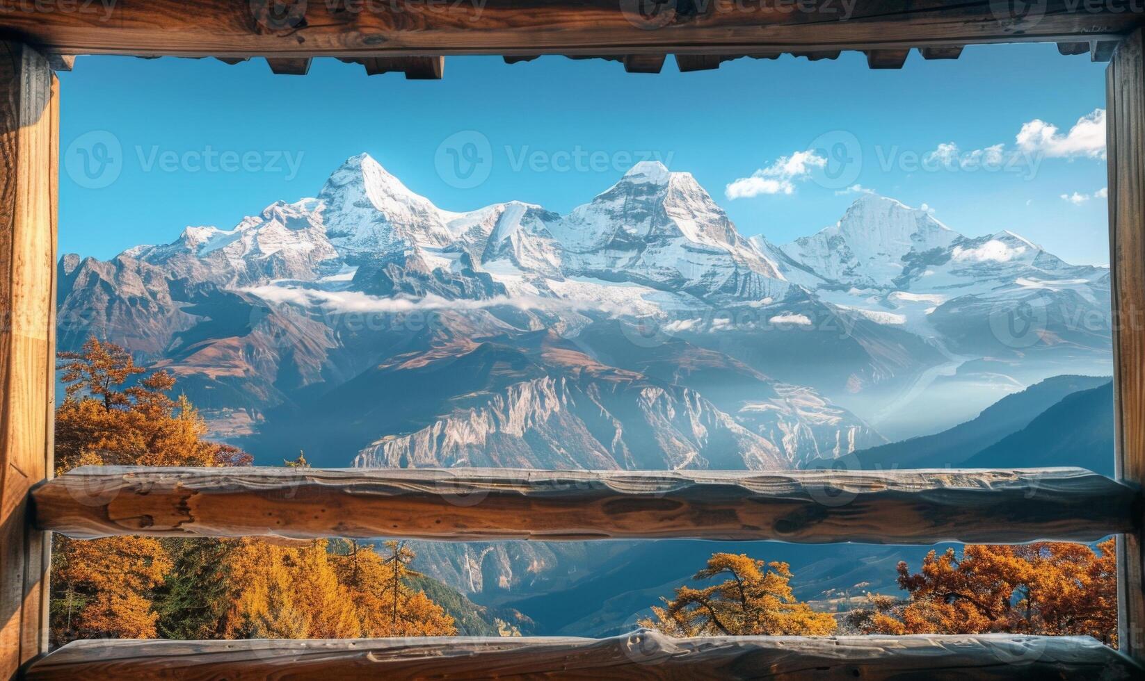 A breathtaking mountain range with snow-capped peaks seen from a cozy wooden balcony photo