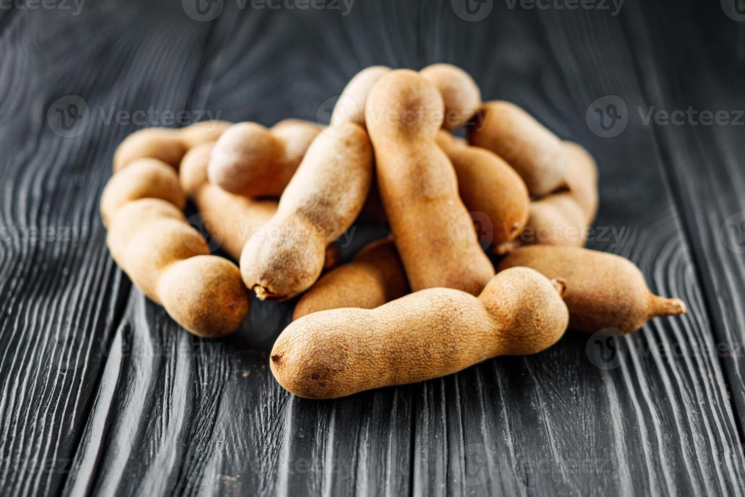 sweet and sour tamarind on a black rustic wooden background photo