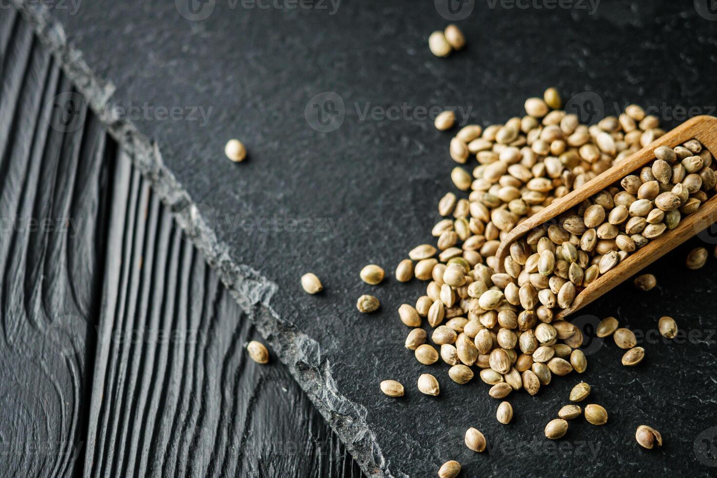 natural hemp seed on black stone background photo