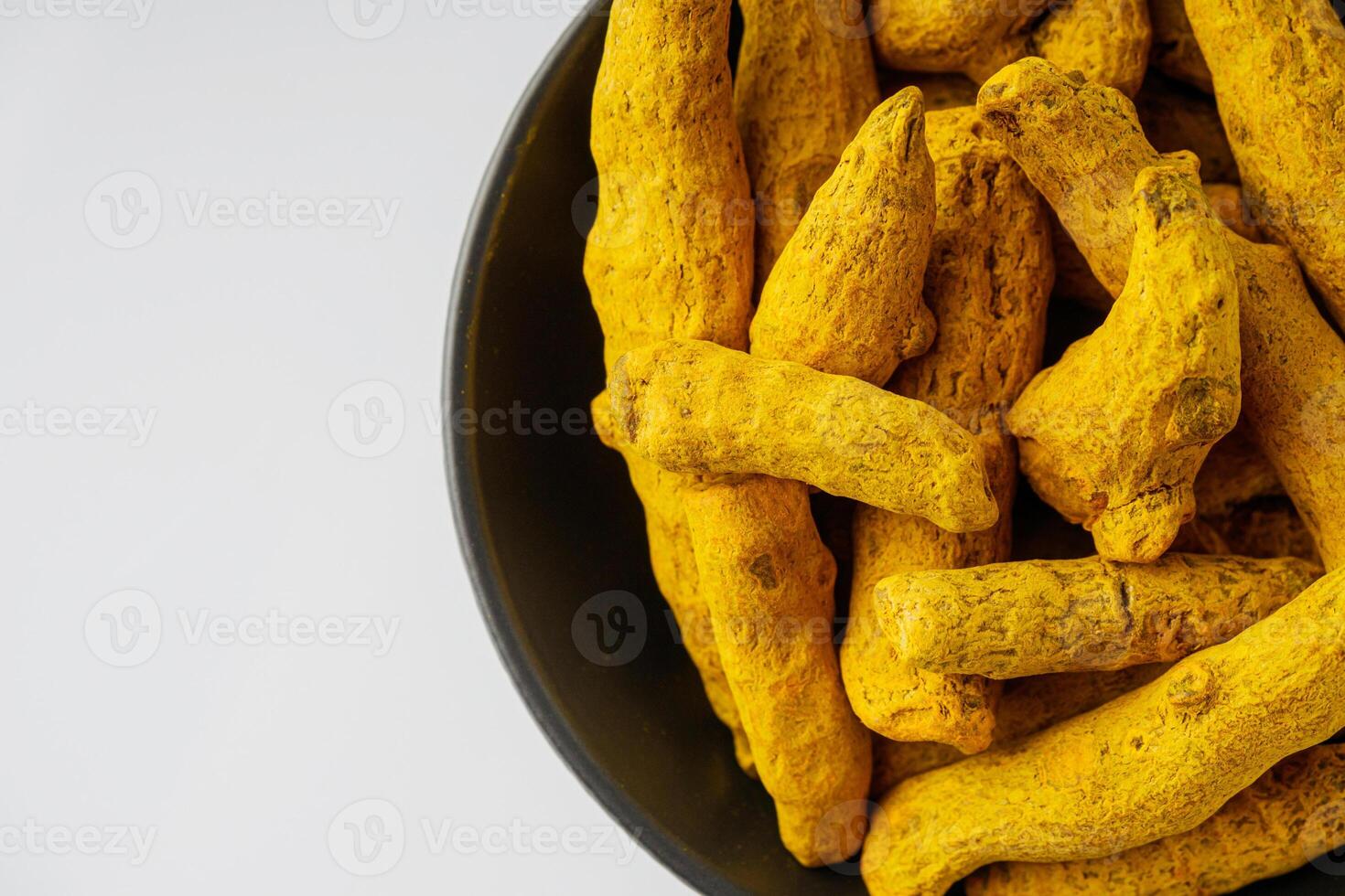 aromatic turmeric root on a white acrylic background photo