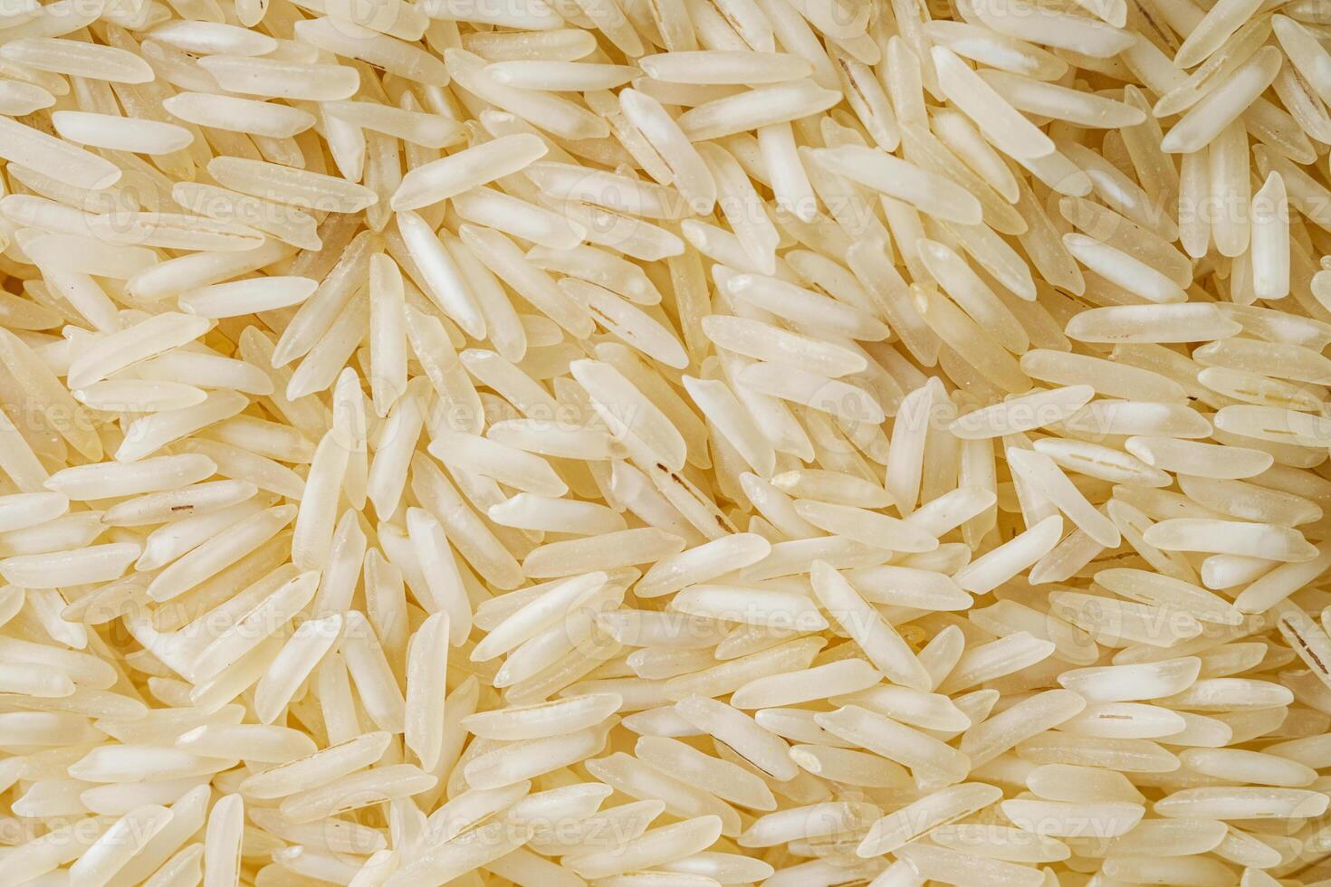 raw basmati rice on a white acrylic background photo