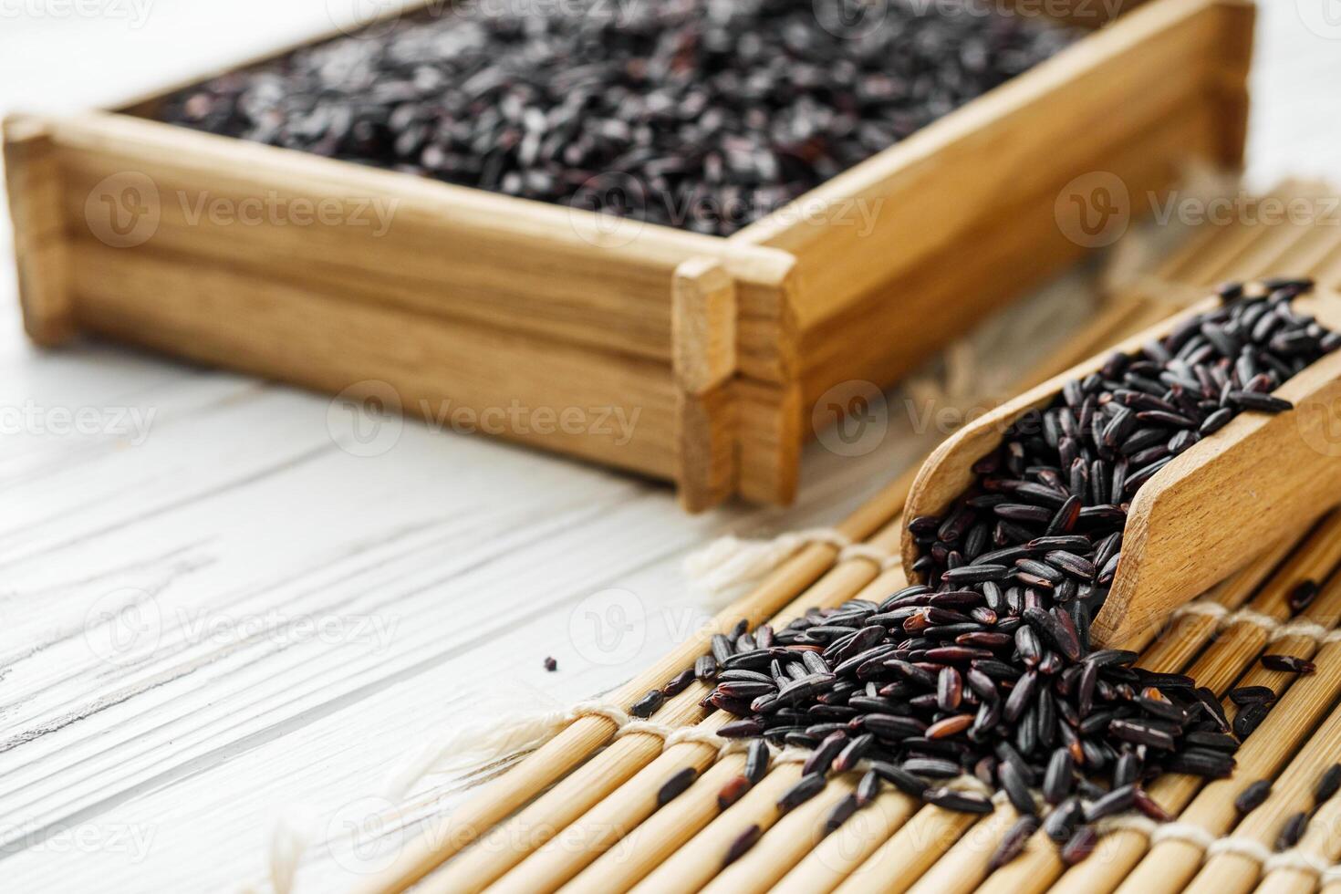 raw fresh black rice on wooden rustic background photo