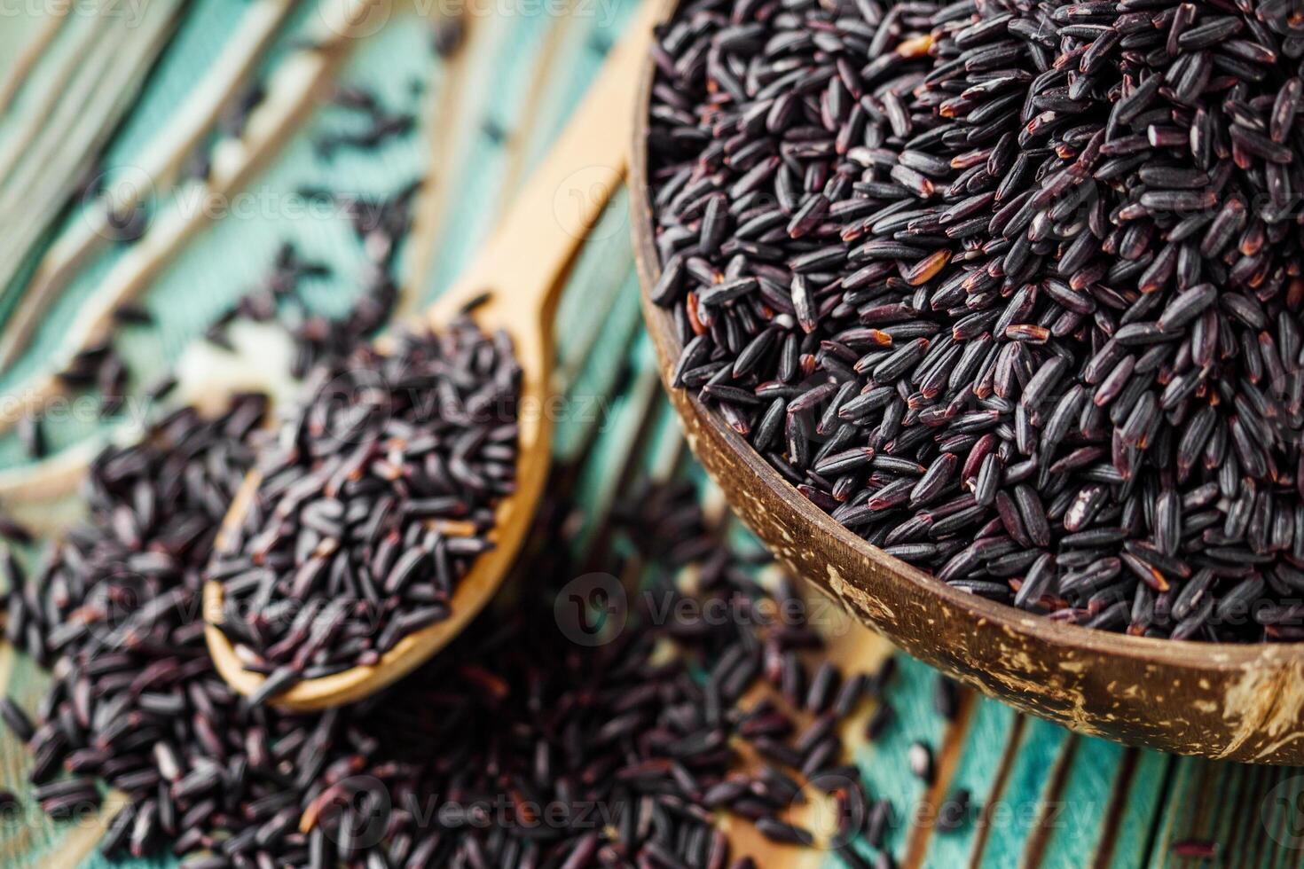 raw fresh black rice on wooden rustic background photo