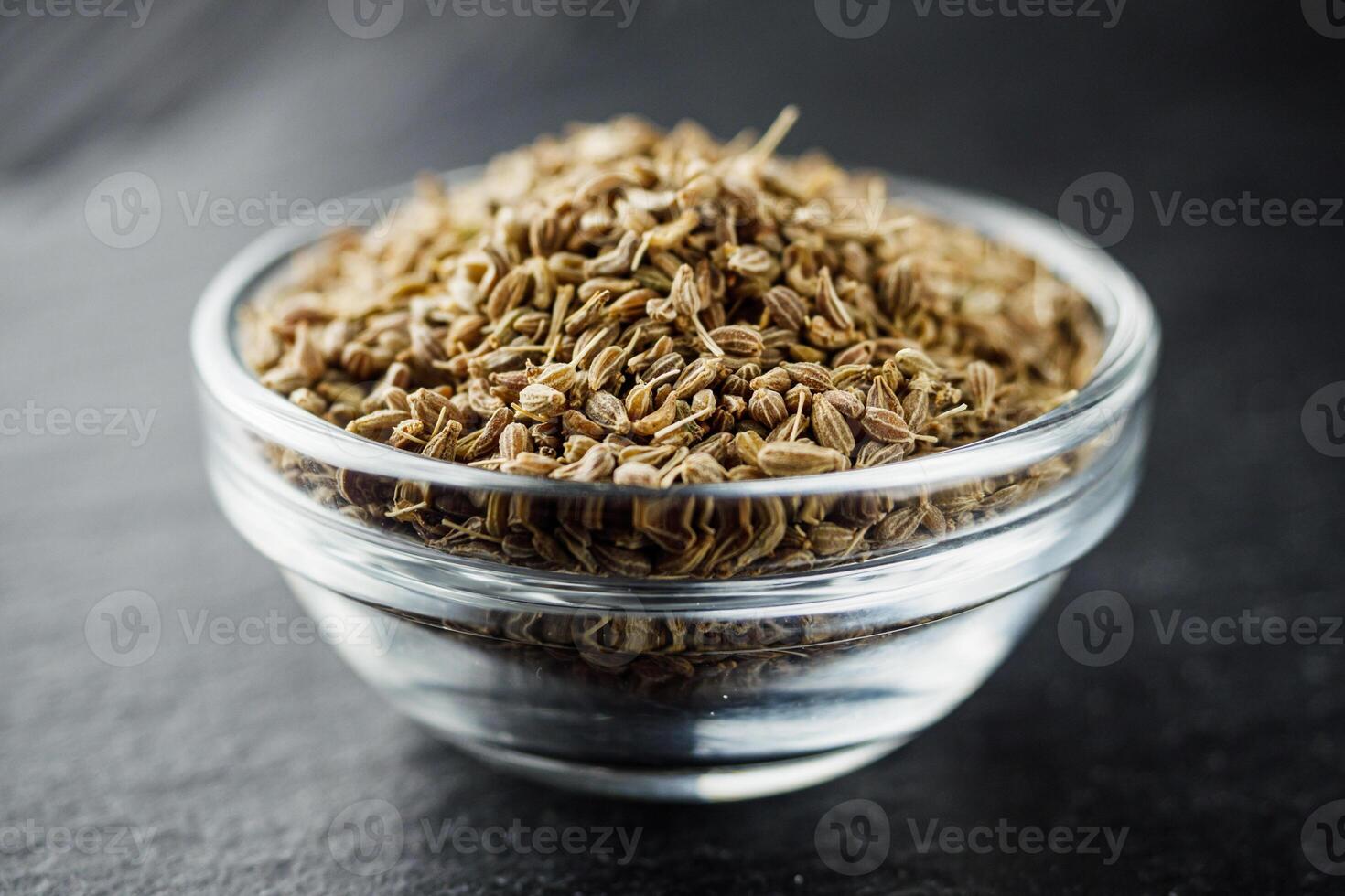 aromatic dry anise seeds on a dark black stone background photo