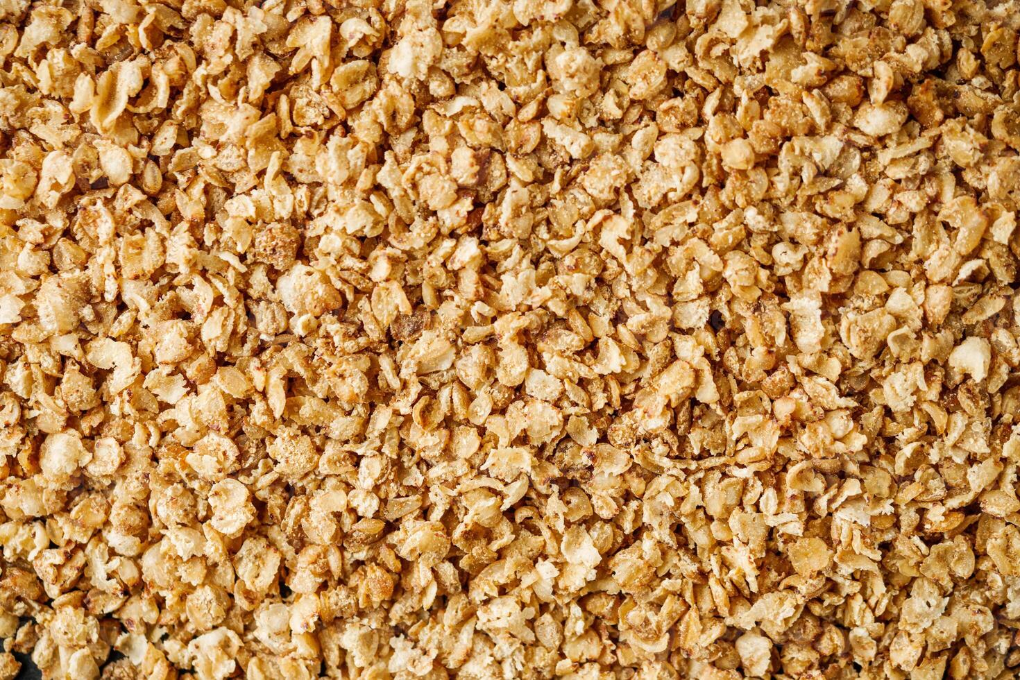 fresh raw buckwheat flakes on a black wooden background photo