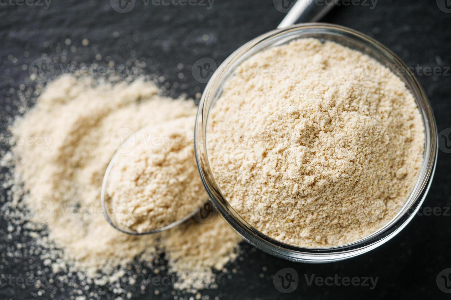 asafoetida aromatic powder on a black stone background photo