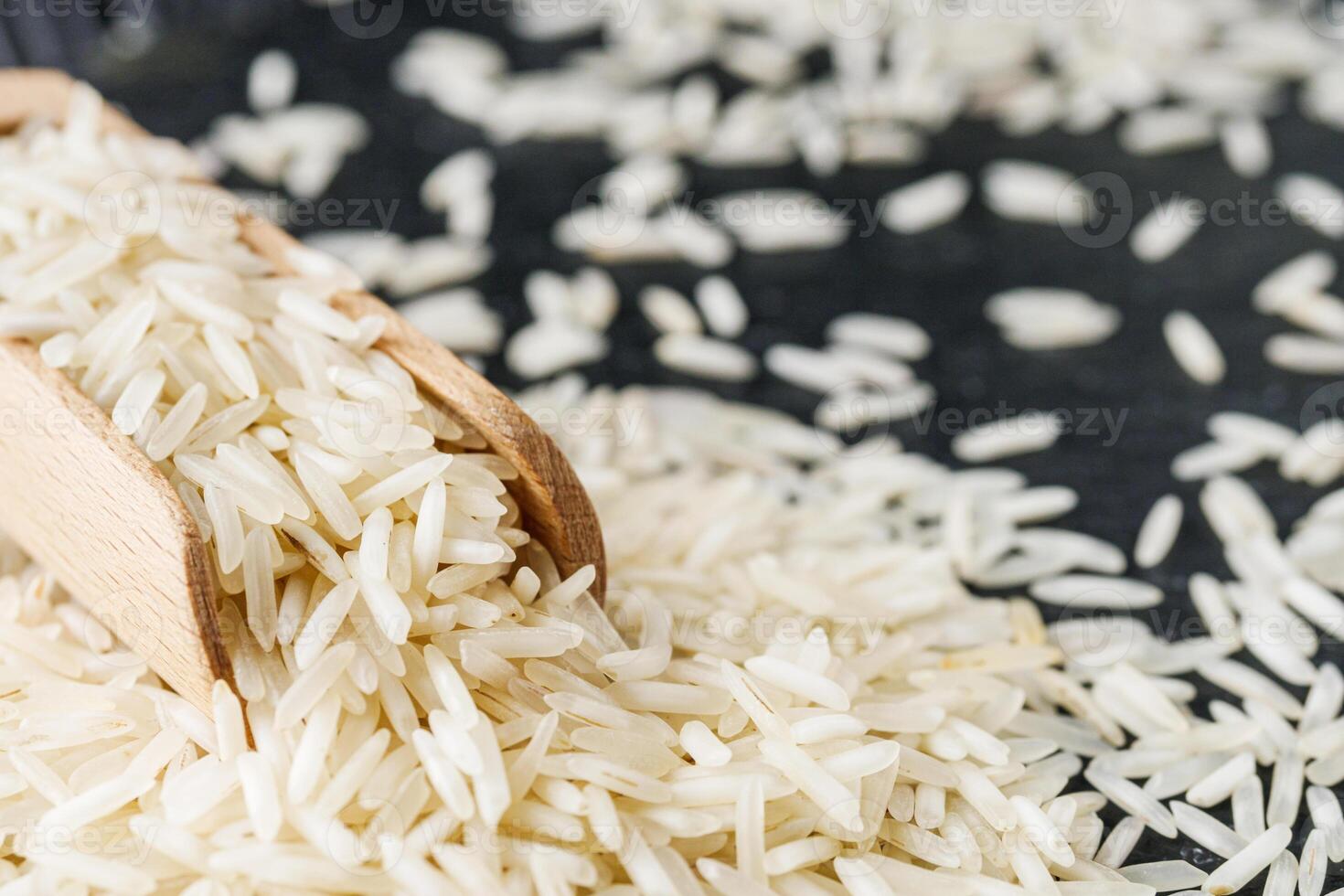raw basmati rice on a black wooden background photo