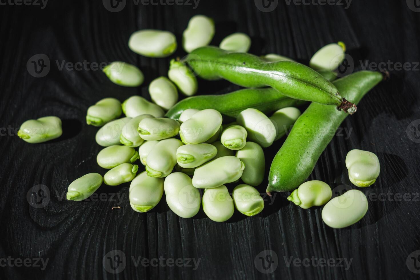 fresh greens broad beans fava on a dark background photo