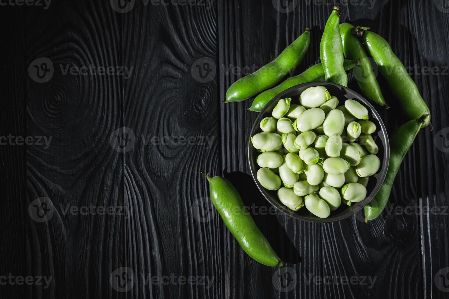 fresh greens broad beans fava on a dark background photo