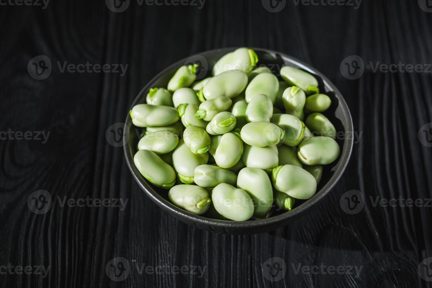 fresh greens broad beans fava on a dark background photo