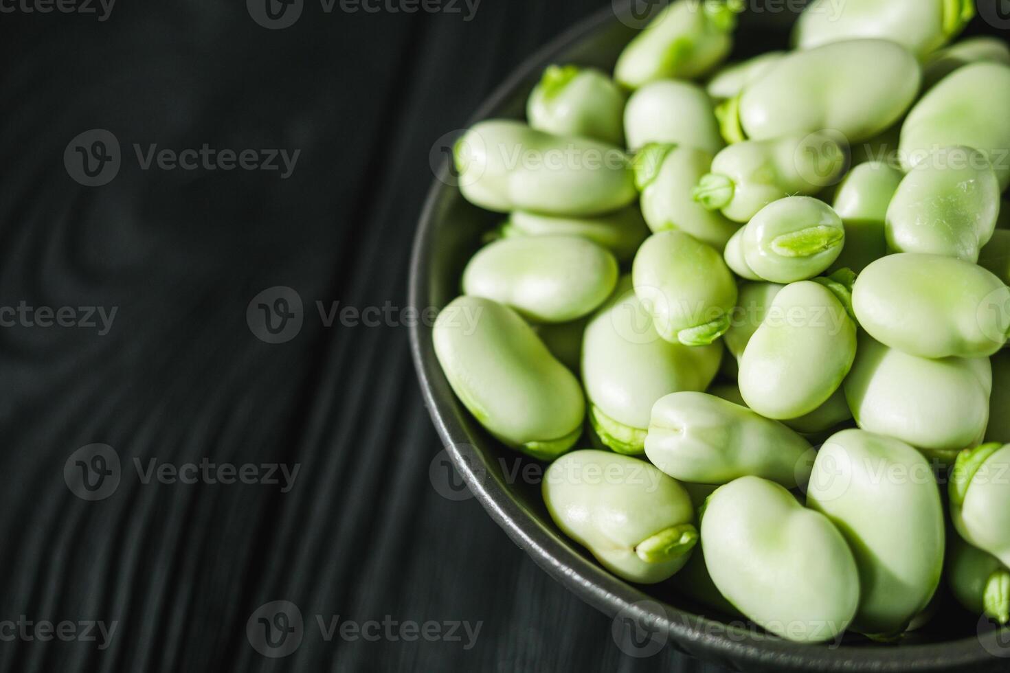fresh greens broad beans fava on a dark background photo