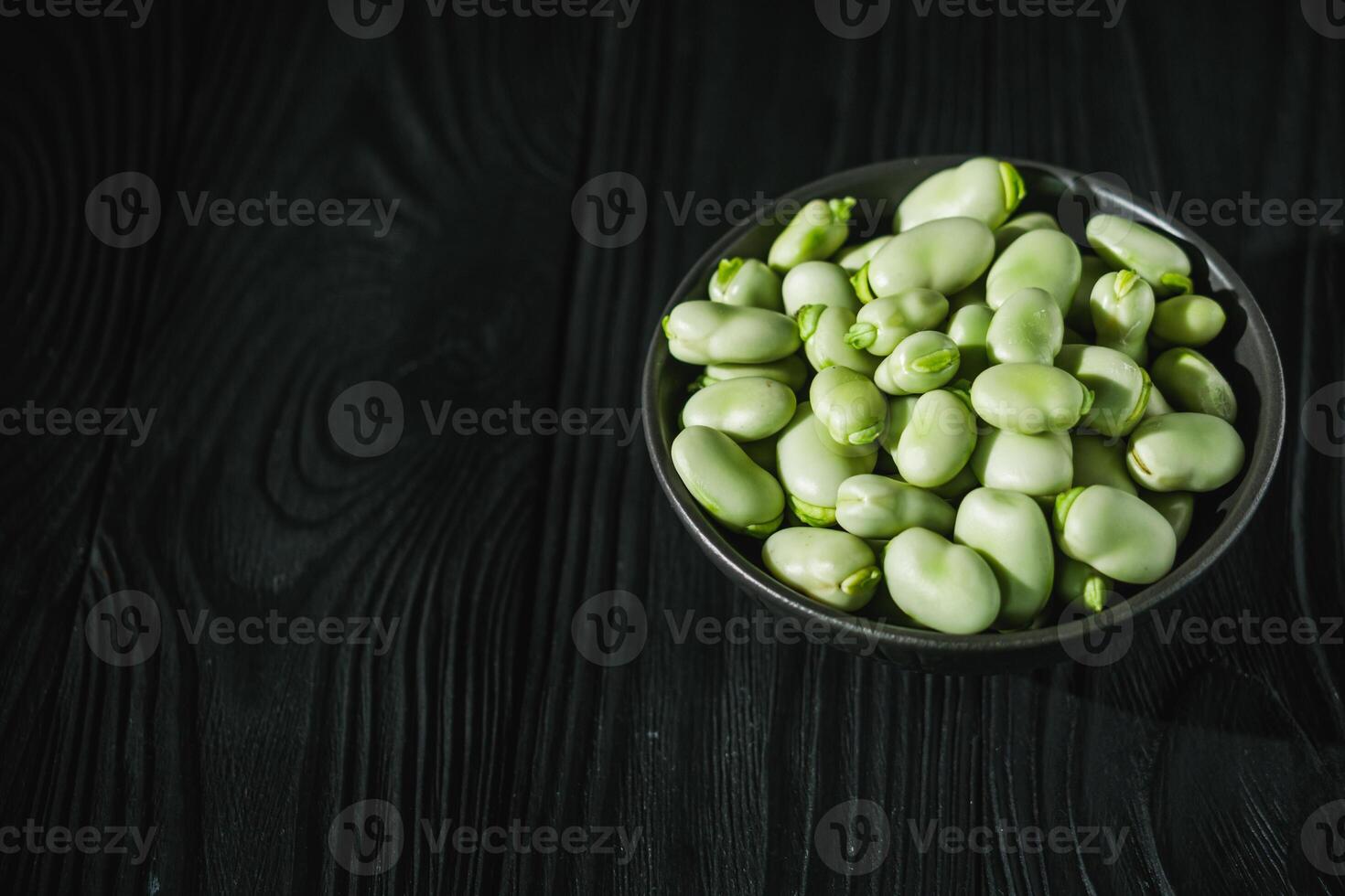 fresh greens broad beans fava on a dark background photo