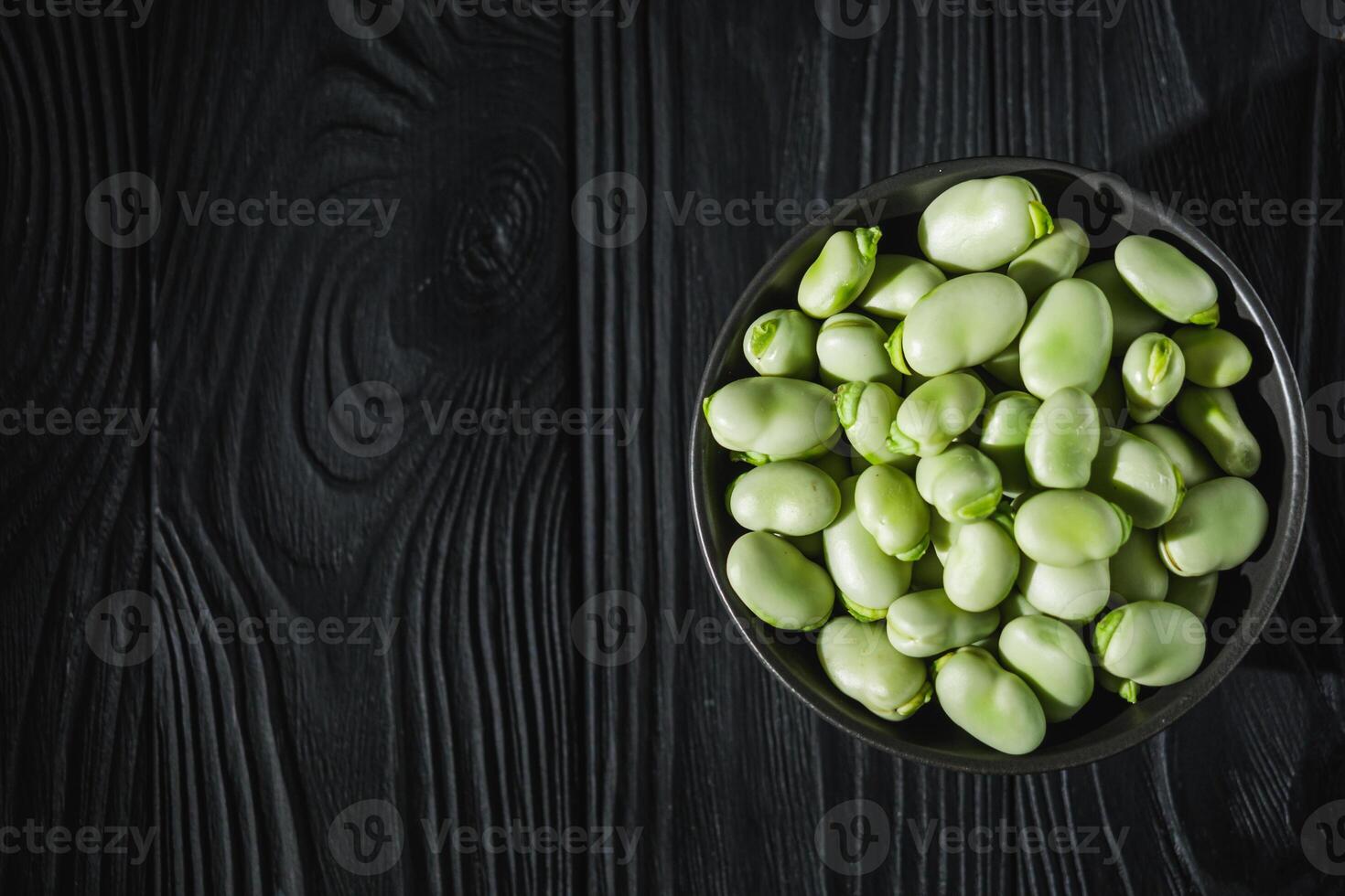 fresh greens broad beans fava on a dark background photo