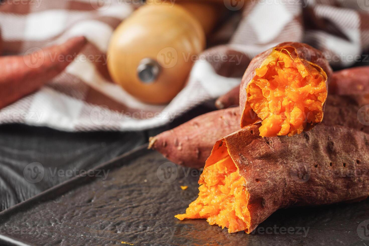 baked sweet potatoes on a dark wooden rustic background photo