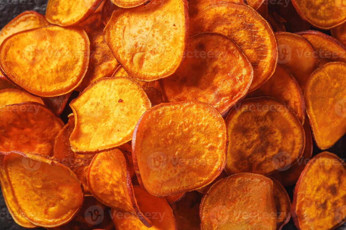 sweet potato chips on a dark wooden rustic background photo