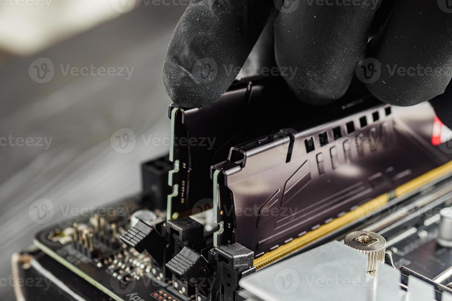 a specialist installs DDR-5 memory on the latest motherboard photo