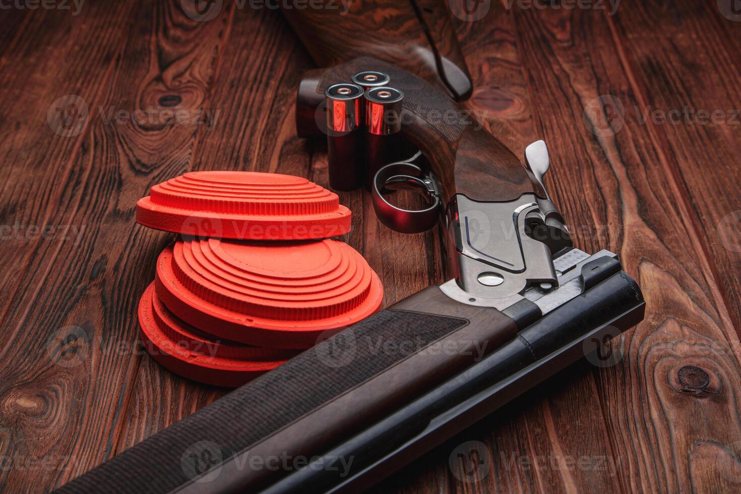 Clay target plates for shooting with rifle on wooden back photo