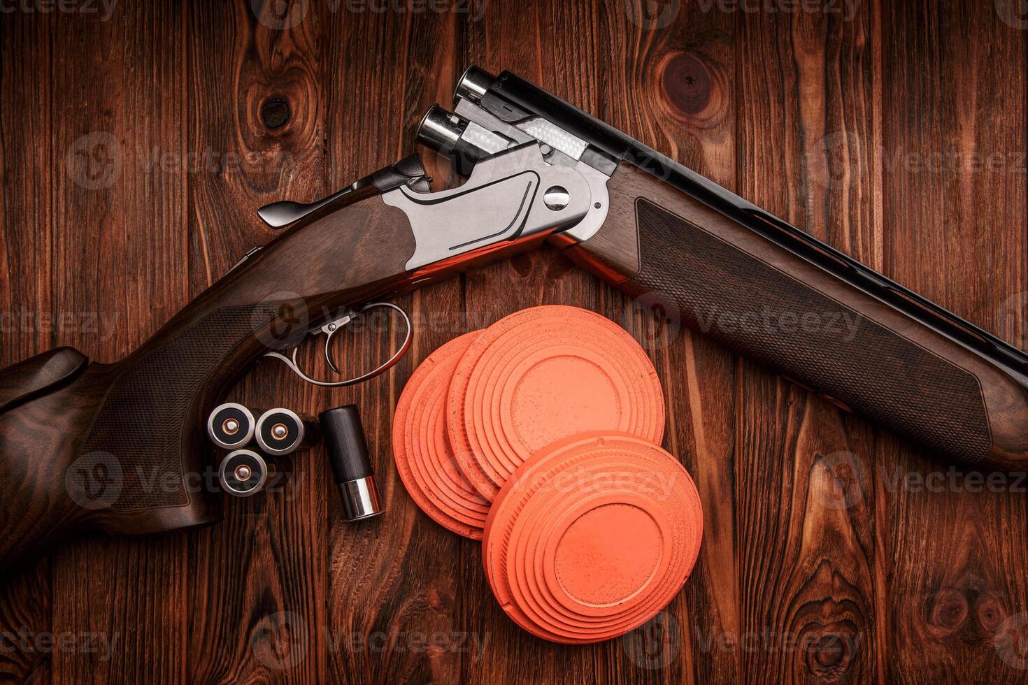 Clay target plates for shooting with rifle on wooden back photo